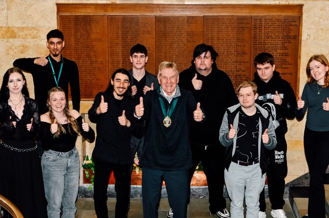Councillor Ged Potter, stands with young people who have completed the journey to work programme in 2025