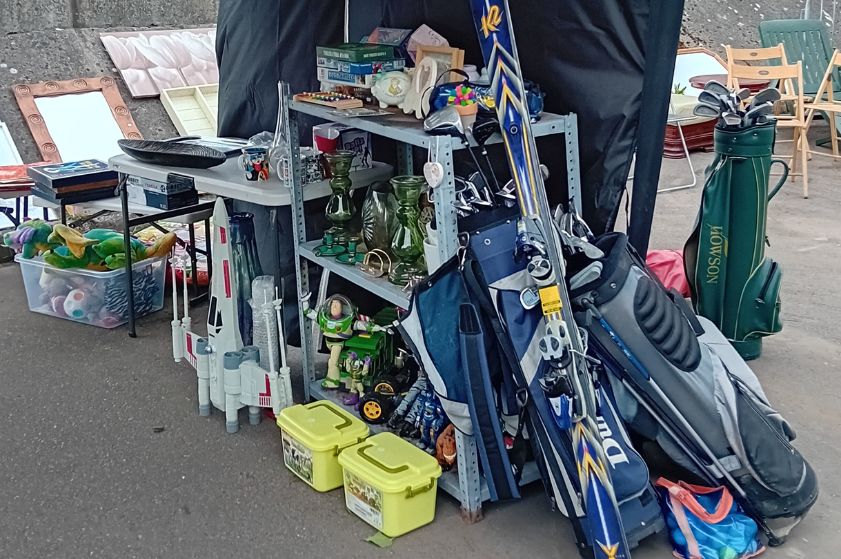 A selection of donated items including golf clubs, toys, and skiis.